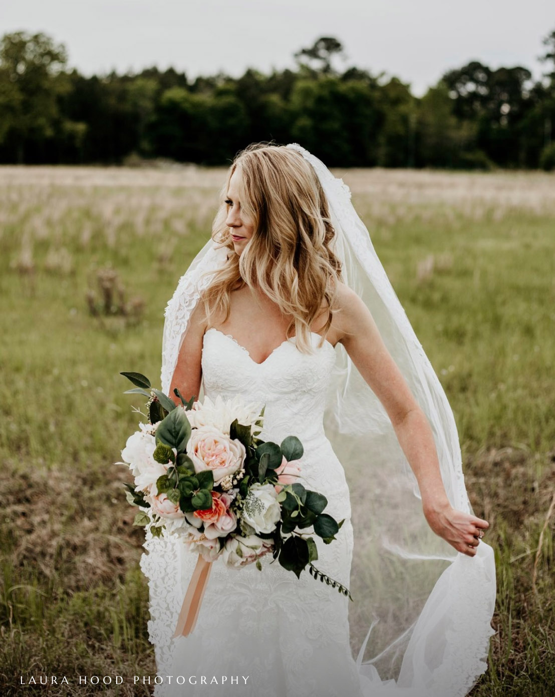 Model wearing a white gown and holding the flowers